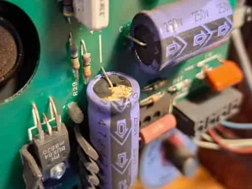 A closer inspection shows how one of the capacitors has stared leaking.